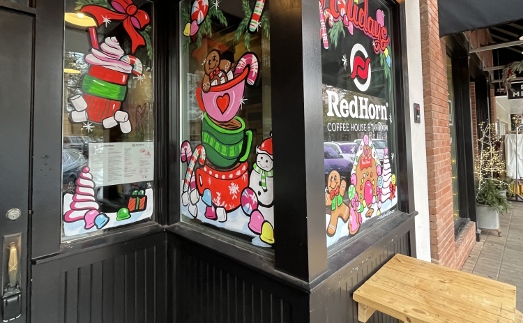 Red Horn Coffee House & Tap Room has holiday art painted on its windows.