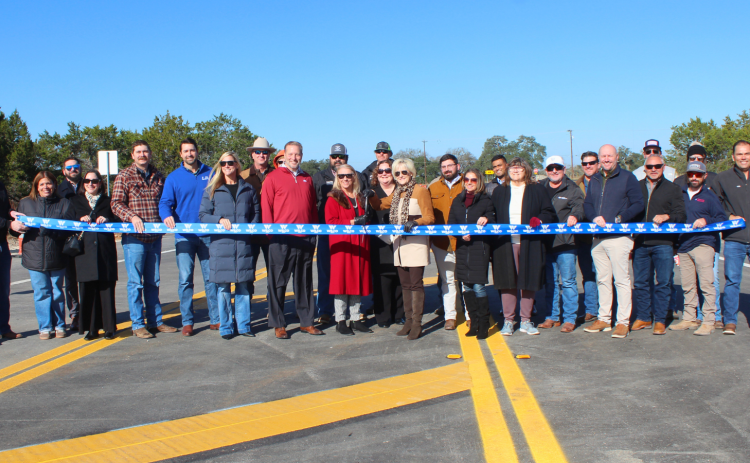 From left, County Judge Steve Snell (in the red sweater), Commissioner Cynthia Long and Valerie Covey, and Liberty Hill Mayor Crystal Mancilla prepare to cut the ribbon before opening Freedom River Parkway, formerly Liberty Hill Bypass, on Tuesday, December 2. Photo courtesy of Williamson County.