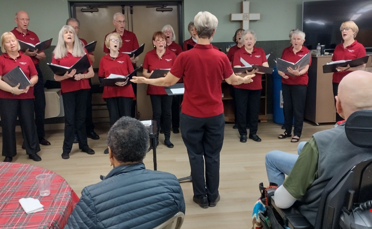 Singers from the Heritage Oaks Chorus, led by Kathleen Bohn, performed Christmas favorites on Wednesday, December 3, during A Gift of Time’s weekly respite at St. John’s Methodist Church. The choir consists of members who live in the Heritage Oaks neighborhood, near the intersection of Williams Drive and Shell Road. The chorus will host a spring concert in May, open to the public at the Heritage Oaks clubhouse.