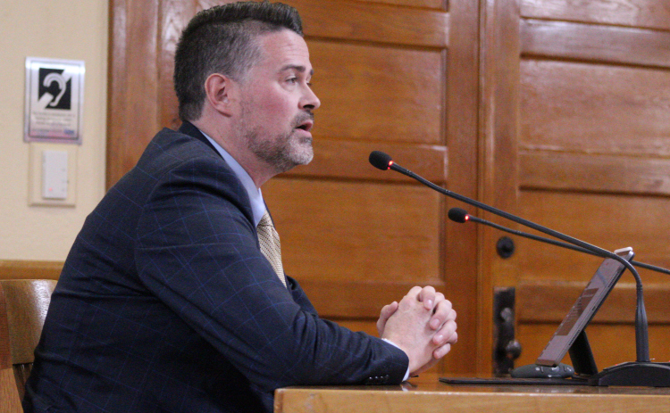 Cameron Glass, director of justice for Kitchell/CEM, Inc., presents the Phase 1 update for the new Jail and Justice Center during the December 17 County Commissioners Court meeting at the historic courthouse. Photo by Nalani Nuylan.