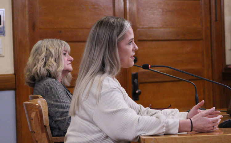 Williamson County Republican Party Chair Michelle Evans, front, explains the party’s wishes for precinct-level voting on Election Day, while Democratic Party Chair Kim Collins Gilby, back, looks on during the January 27 Commissioners Court meeting. Photo by Nalani Nuylan.