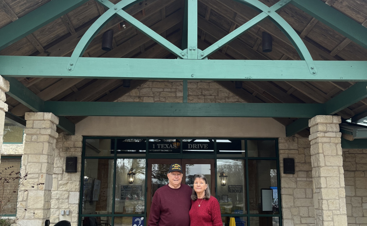 Beverly and John Henry in front of the Sun City Sales Center.