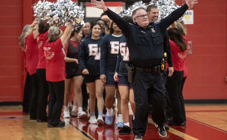 Georgetown Assistant Police Chief Roland Waits leads his team onto the court as the the police department takes on a  Granny Basketball Team, the Texas Fire Ants, during a matchup held at East View High School on Saturday, January 17, 2026.  The game, won by the Fire Ants, with a final score of 55-47,  benefits the Carver Center for Families.      Photo by Andy Sharp.