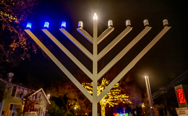 A Menorah placed by Beit Messiah of Georgetown, TX is pictured at Founder’s Park  on Tuesday, December 16, 2025.  The congregation’s Lights of Hanukkah will hold events here on December 20th and December 21st beginning at 6p.m. each night.   Seasonal lights are abundant in Downtown Georgetown this year.  Photo by Andy Sharp.