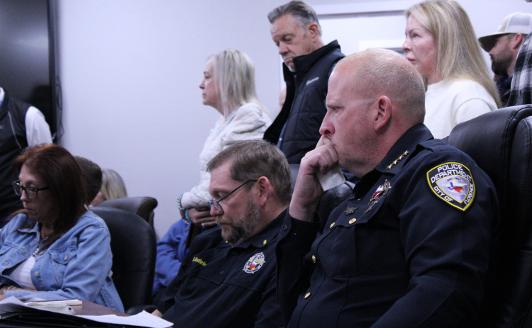 Florence Police Chief Wayne Thompson, right, gets tearful listening to 15 people vocalize their support of him during the January 20 special-called city council meeting. Photo by Nalani Nuylan.
