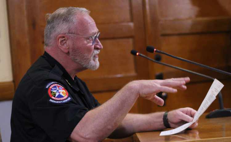 Bruce Clements, director of emergency management for Wilco, explains the flood resource grant from the Texas Water Development Board during the February 10 Commissioners Court meeting. Photo by Nalani Nuylan.