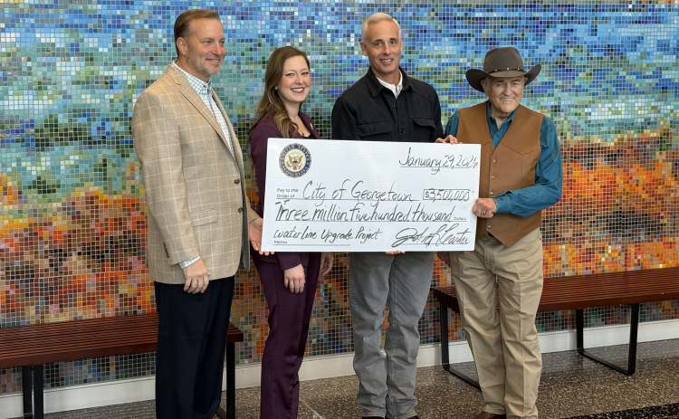 Williamson County Judge Steve Snell, State Rep. Caroline Harris Davila, Georgetown Mayor Josh Schroeder, and U.S. Rep. John Carter pose with a check for $3.5 million.