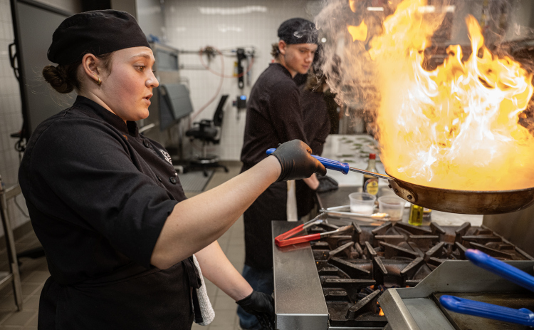 Senior Riley Kinser, an East View High School culinary arts student, keeps a close eye on Asian Green Beans she and her fellow students were preparing for attendees at the Georgetown ISD State of the District gathering held at the Future Ready Complex on Friday, March 6, 2026.  District students and staff were on hand to demonstrate their skills in various areas.  Superintendent Dr. Devin Padavil, joined by several GISD students, also gave a talk near the end of the program. Photo by Andy Sharp.