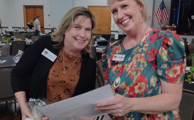 Gift of Time Executive Director Becky Folta-May and Activities Coordinator Jeanette Workman review seating arrangements before the start of the F7 Group Foundation’s March 5 gala that drew more than 320 people to the Sun City Ballroom.