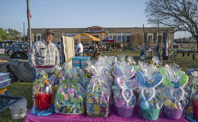 Darvin Bamsch looks over a large collection of Easter baskets for sale at the Jonah and Weir Community Sale, held at the Jonah Community Center on Saturday, March 22, 2025.
