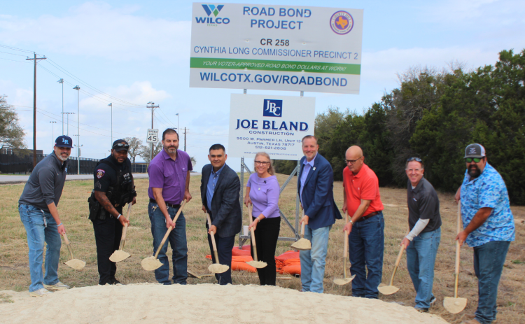 Breaking ground for the Legacy Ranch Drive project, from left, are Mark Koller, Legacy Ranch High School principal; John Gardner, Liberty Hill ISD Police Department; Dustin Akin, Liberty Hill ISD executive director of operations; Alex Salazar, Liberty Hill ISD deputy superintendent; Commissioner Cynthia Long, Precinct 2; County Judge Steve Snell; Kyle Klussmann, Joe Bland Construction; Chase Myers, American Structurepoint; and Steven Shull, HNTB. (Photo courtesy Williamson County)