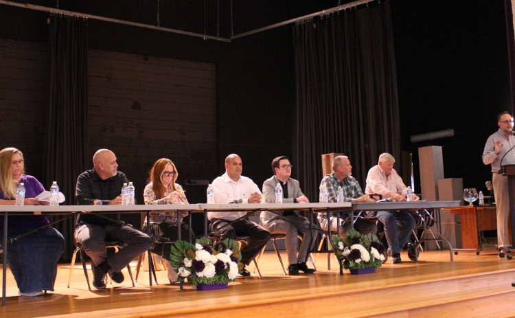 From left, Renee Morgan, Forrest Hyde, Ashley Gilland, Jose Perez, Brett Banks, Ben Daniel and David Merideth participate in a candidate forum hosted by the Florence Chamber of Commerce in the Florence High School Cafeteria on April 16. The form was moderated by Justin Gibson, standing. Photo by Nalani Nuylan.