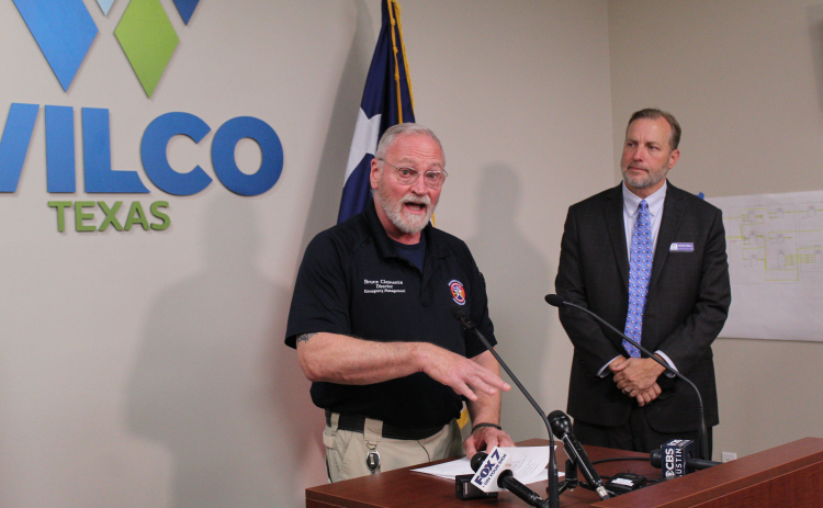 Williamson County Emergency Management Director Bruce Clements (left) provides an update during a press conference on April 21 about a Flash Flood Warning, triggered by continuous rain over the past few days. County Judge Steve Snell (right) listens in. Photo by Nalani Nuylan.