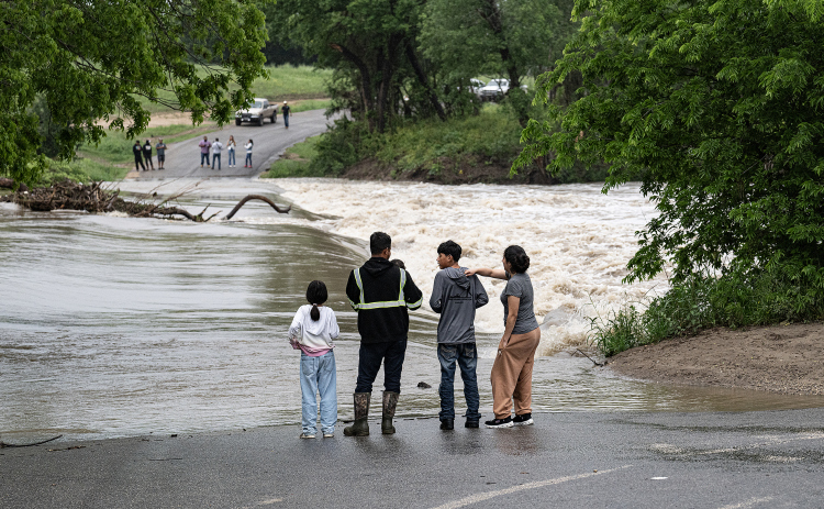 County Road 100 at Mankin’s Crossing was impassable as the San Gabriel River covered the bridge at approximately 6:30pm on Tuesday, April 21, 2026. Rain was present throughout the day in Williamson County, closing some of the area’s roads.      Photo by  Andy Sharp.