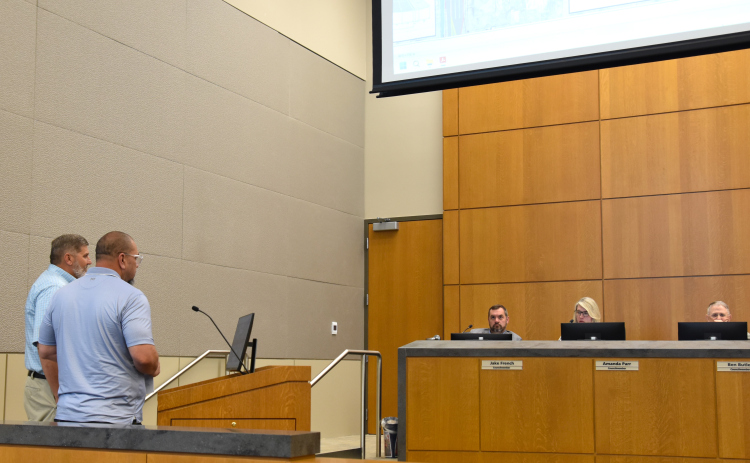 Trae Sutton, Vice President and COO of KPA Engineers, far left, and Lua Saluone, left, Transportation Manager, present the schematics for Austin Avenue and University Avenue to city council during the April 28 meeting. (Photo by Kaitlyn Wilkes)