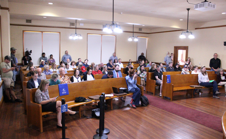 Residents from Carlson Place, Saddle Creek, Pinnacle, Churchill Farms, Summercrest and University Park fill the Commissioner Courtroom during the May 19 meeting. Photo by Nalani Nuylan.