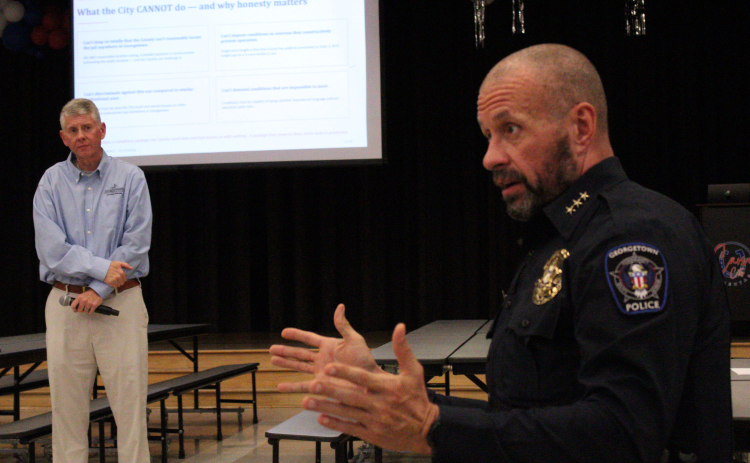 Georgetown Chief of Police Cory Tchida, right, and Ben Stewart, Georgetown City Council District 7, left, answer questions about Williamson County’s Justice Complex in a town hall on Thursday, May 21, at Caver Elementary. Photo by Nalani Nuylan.