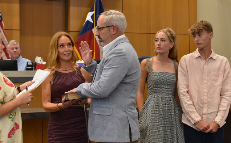 Doug Noble, who took over for Shawn Hood for District 2, is sworn in with his wife Kasie and his children during his swearing in on May 12.