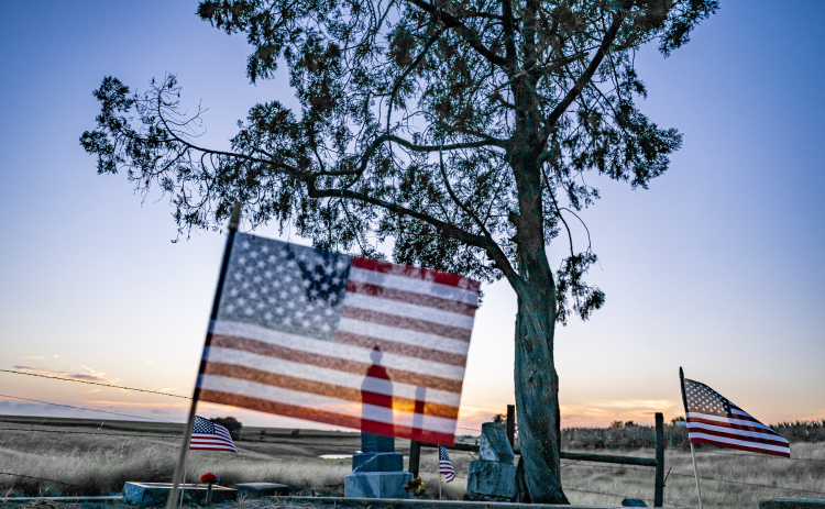 American flags adorn burial sites at Mager Cemetery on Saturday, June 13, 2026.  They were placed this weekend by volunteers from the Hermann Sons Coupland-New Bern Lodge.  The flags coincide  with Flag Day on Sunday, June 14, 2026.   Photo by Andy Sharp.