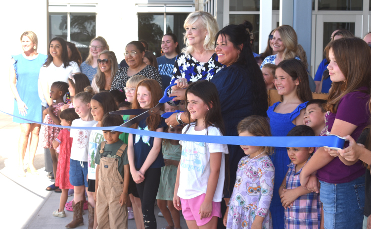 Future Berry Creek students, staff, and JISD trustees get ready to cut the ribbon in the school’s opening ceremony. Center are principal Lara Hutchinson, left, and JISD Board President Jenny Arnold. Photos by Katherine Hamilton