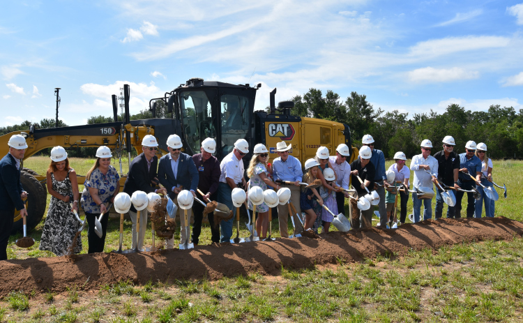 Representatives from the YMCA, Wellspring United Methodist Church, SportClips, the City of Georgetown, H-E-B, the WD Kelley Foundation and the Georgetown Health Foundation gather to turn dirt on the SportClips Family YMCA. (Photo by Kaitlyn Wilkes)