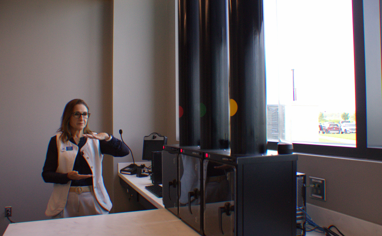 Connie Odom, Williamson County's director of communications and media relations, gives a tour of the new Tax Assessor-Collector's office at the new County Administration Building on June 22. This drive-through will allow residents to get new license plates. Photo by Nalani Nuylan.