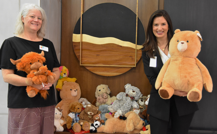 Brooke Cox, left, the development and event coordinator at the Williamson County Children’s Advocacy Center, and Annika DiNovi, executive director of Touchmark at Georgetown, pose with some of the stuffed animals brought to Touchmark Georgetown as part of a donation drive for the CAC. (Photo by Kaitlyn Wilkes)