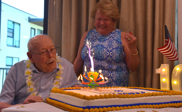 Grover Trytten, left, blows out his birthday candles with his daughter, Lynn Trytten Owens looking on. The 105th birthday party for Mr. Trytten took place on July 22 at Touchmark at Georgetown. (Photos by Kaitlyn Wilkes)