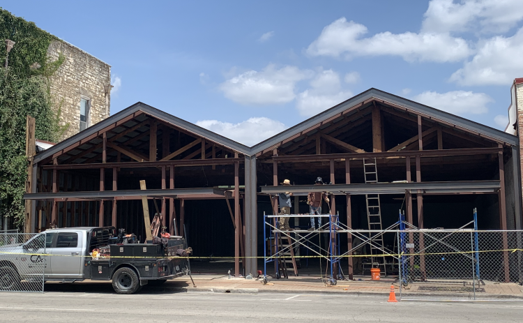 Contractors renovate a downtown space at 817 South Austin Avenue July 29. Projects like this in the future will have to follow updated Unified Development Code standards for downtown structures. New Georgetown building and environmental rules will go into effect this November. (Photo by Kaitlyn Wilkes)