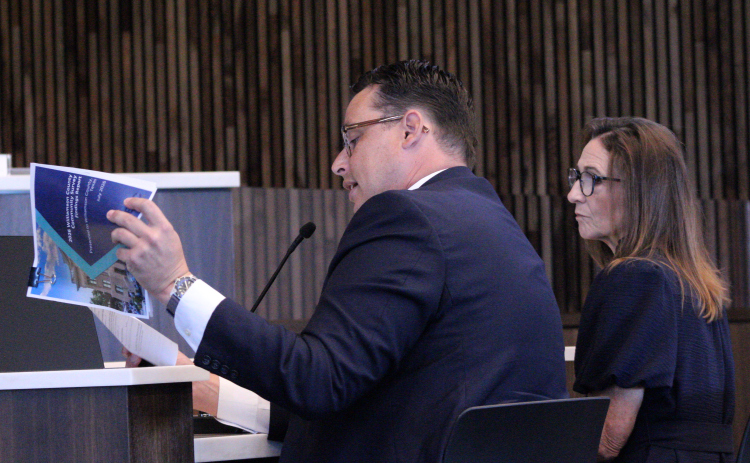 Ryan Murray with ETC Institute, left, reads findings from a recent resident survey to the Williamson County Commissioners Court, August 25. Williamson County Director of Communications Connie Odom, right, joins him. Photo by Nalani Nuylan.