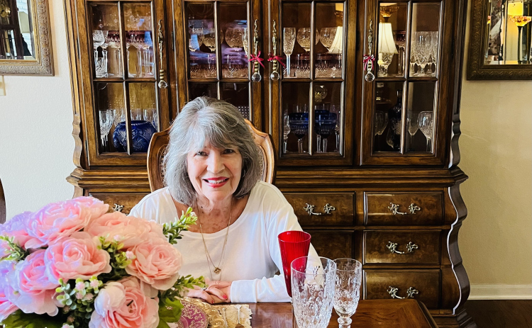 Georgetown resident Virginia Cambron sits at her table with part of her large collection of glassware and fine china.