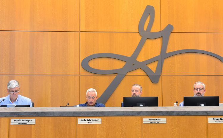 From left, David Morgan, city manager, Josh Schroeder, mayor, Kevin Pitts, council member and Doug Noble, council member, listen to the first reading of the 2027 Fiscal Year budget on August 25. (Photo by Kaitlyn Wilkes)