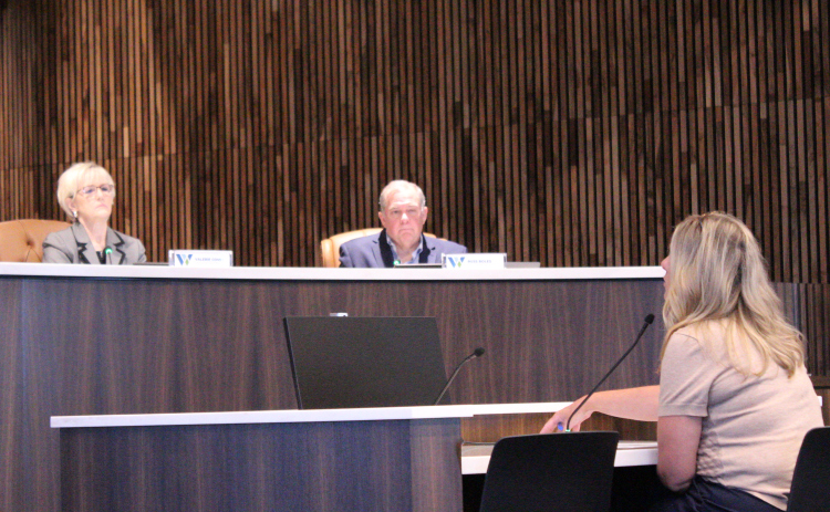 County Manager Rebecca Clemons (front) proposes three draft plans for future use of county facilities to county officials during the September 22 Commissioners Court. Photo by Nalani Nuylan