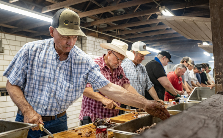 A crew prepares smoked meats for meals  during the Fall Bazaar held at Saints Cyril & Methodius Catholic Church  on Sunday, September 6, 2026.