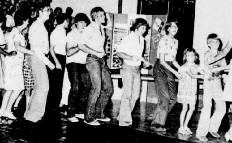 September 12, 1976: GETTING IN ON THE ACTION - Georgetown folks get in on the action at the Up with People concert Tuesday night as they bunny hop around Southwestern University's new Sid W. Richardson Physical Education Center. The program, designed to establish a creative framework for communication and interaction between people of varied backgrounds and across all ages, seems to be working as Georgetownites bunnyhop, swaying arm-in-arm to the music, singing and clapping.
