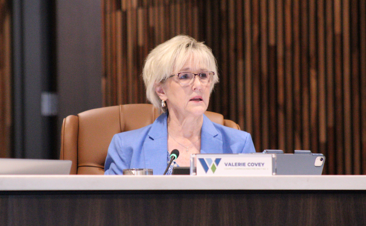 Williamson County Commissioner Valerie Covey of Precinct 3 explains the resolution to lower the debt cap for the Somerset Hills Road Districts 3 and 4 during the Road District Commissioners Court meeting, September 29. Photo by Nalani Nuylan.
