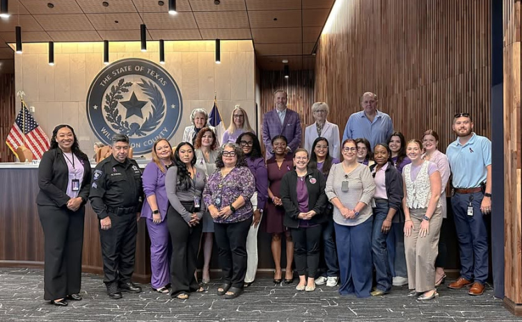 Staff from Yesterday’s Gone, Hope Alliance and law enforcement pose with the Williamson County Commissioners to spread awareness of domestic violence and abuse. Purple is the official awareness color. Photo courtesy of Williamson County