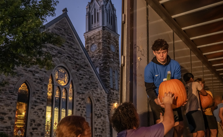 Chase Helm, a member of the Georgetown High School soccer team, helps unload 3,000 pumpkins at Georgetown’s First United Methodist Church on Wednesday, October 7. The truckload of pumpkins arrived at the church just before 7 p.m., a 13-hour drive from Farmington, New Mexico. Another 1,500 pumpkins will arrive on October 18. Pumpkins will be available through October 31. (Photos by Andy Sharp)