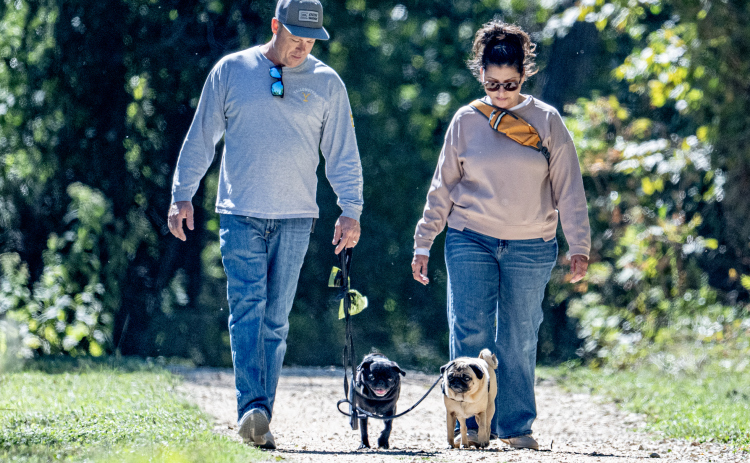 Justin and Ivette Fenton enjoy a walk with their pugs Pepper and Genny on Saturday, October 17, 2026, a cool autumn afternoon at Berry Springs Park & Preserve.  Photo by Andy Sharp.