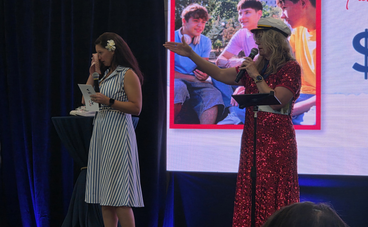 Marissa Austin, left, wipes her tears as audience members donate to Court Appointed Special Advocates of Williamson County during its Wine, Women and Shoes fundraiser, September 26. Photo by Nalani Nuylan.