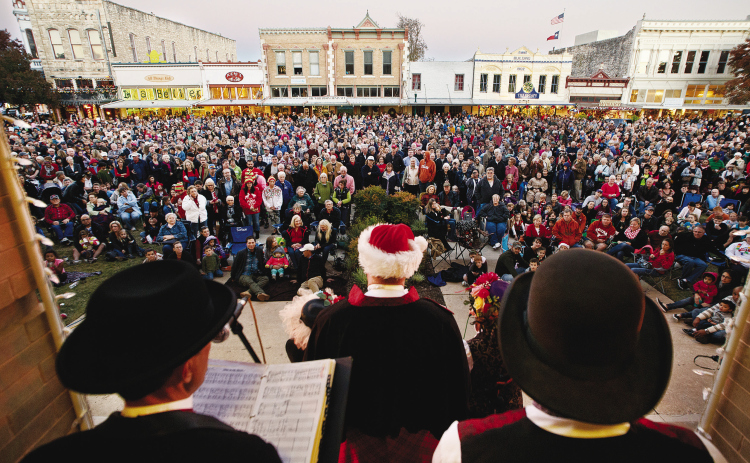 On the steps of the historic Williamson County Courthouse, the Austin Carolers entertain the crowd gathered at the Georgetown Square for the Lighting of the Square November 28, 2014. A large crowd filled the streets of downtown Georgetown for this annual holiday tradition. SUN ARCHIVE