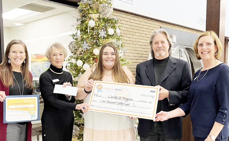 Janelle McNeill, Marsi Liddell, Chandler Stancliff, Bob Blomquist and Pam Carlson gather at First Texas Bank to hand off a $1,000 check for CareBOX Tuesday, November 29.