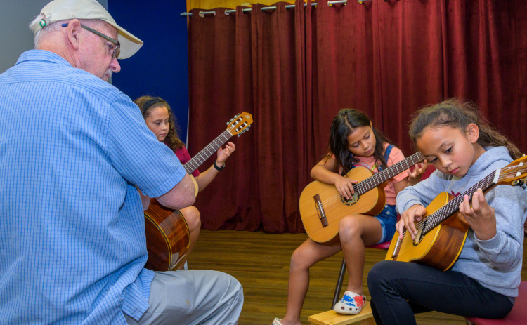 Kevin Taylor teaches Aylah, 11, Liyah, 10, and Ahni Vasquez, 9. GARY HOOK